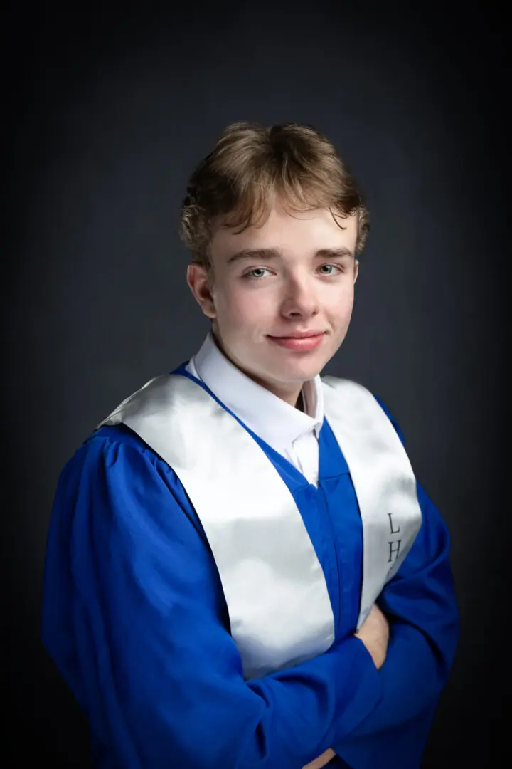 A young man in graduation attire posing for the camera.