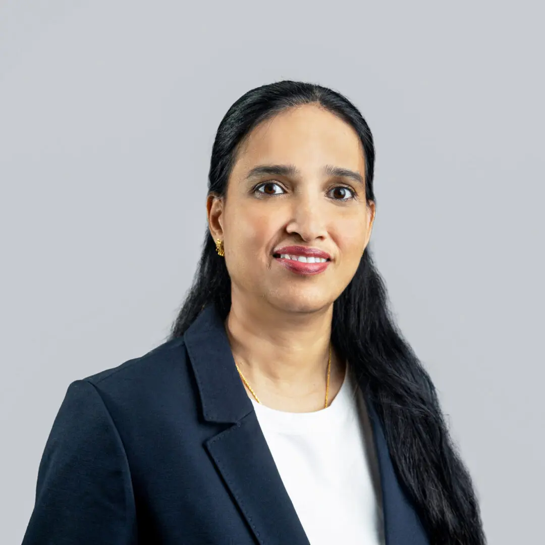 A woman in a suit and white shirt