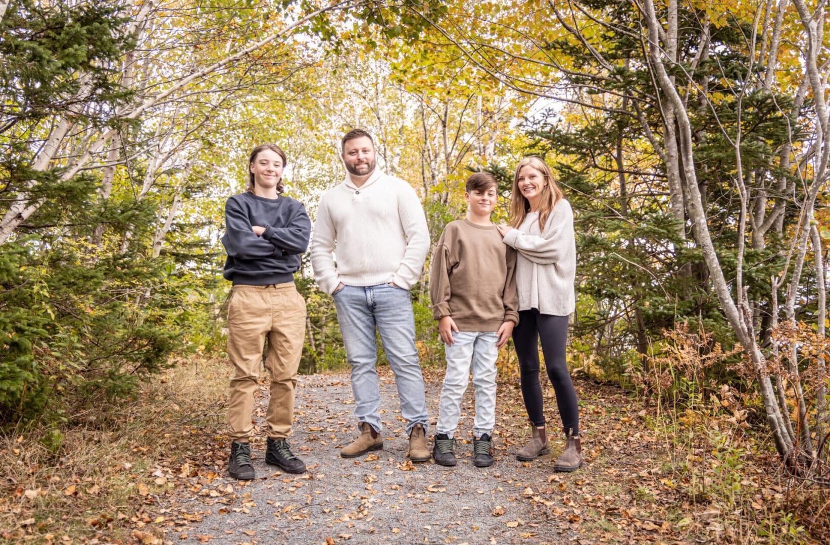 A family posing for a picture in the woods.