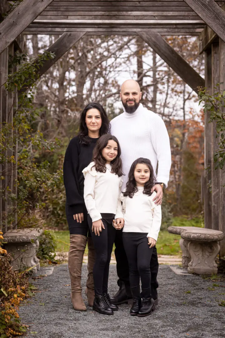 A family posing for a picture in the woods.