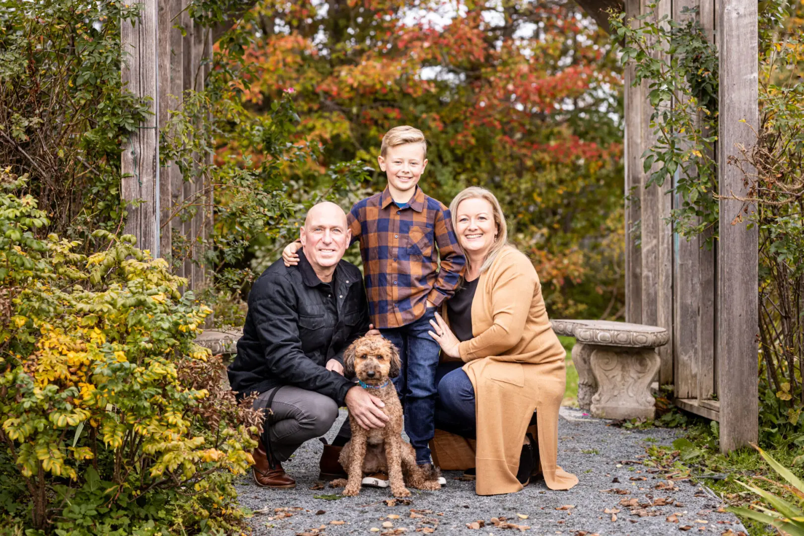 A family posing for a picture with their dog.