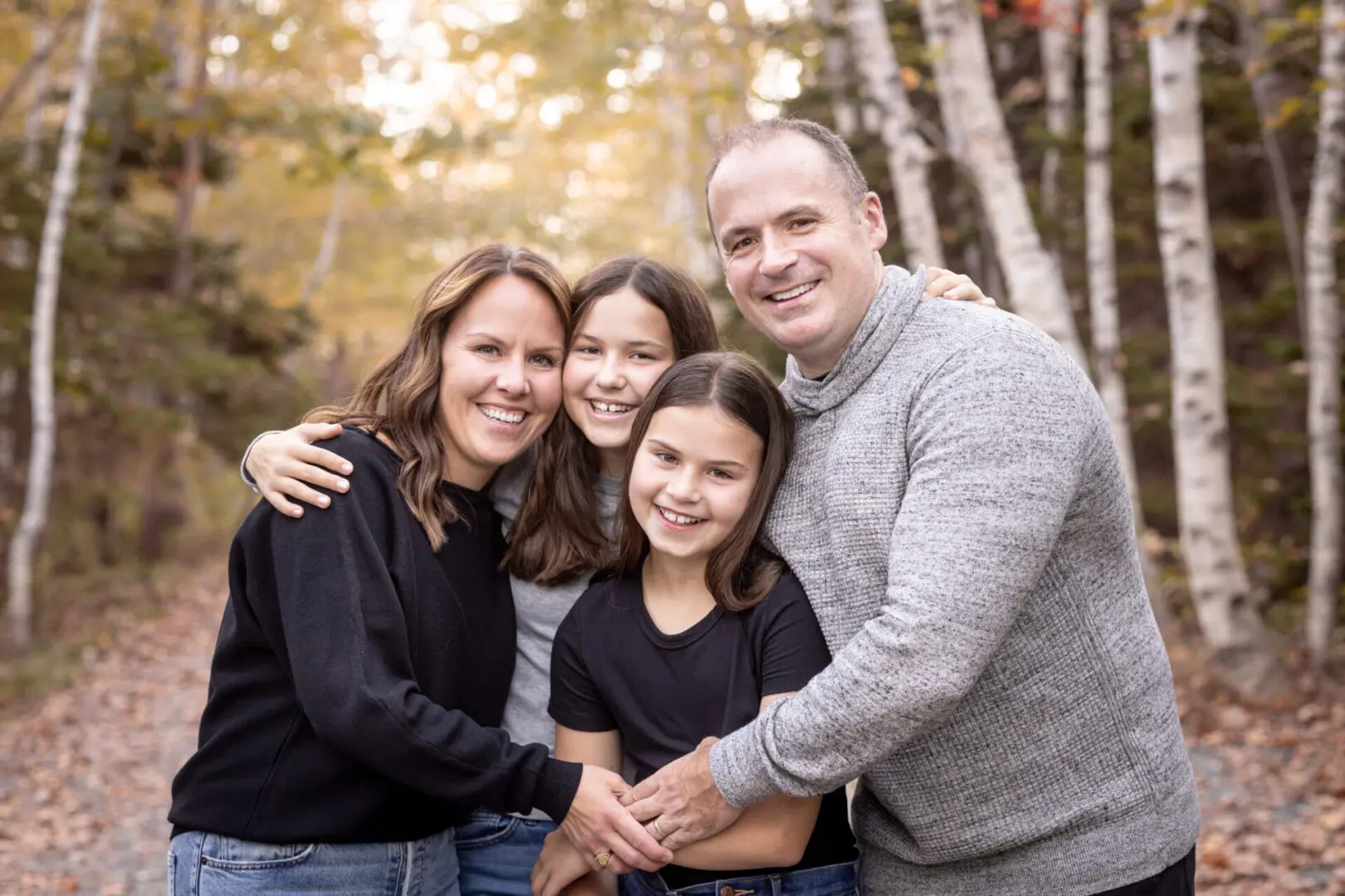 A family posing for a picture in the fall.