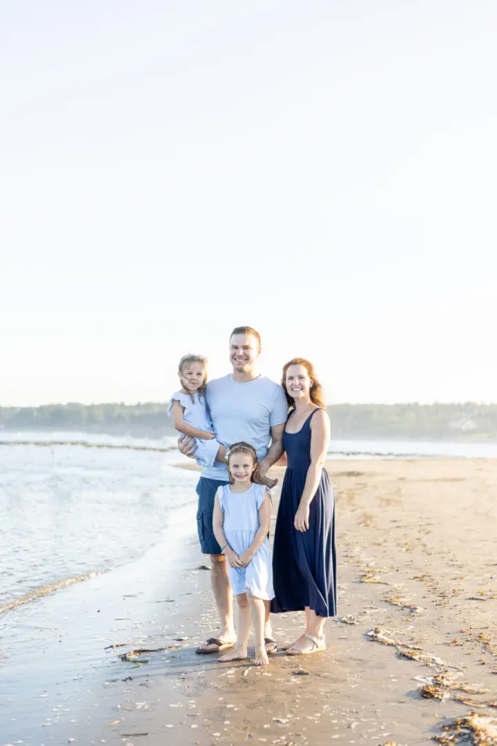 A family posing for a picture on the beach