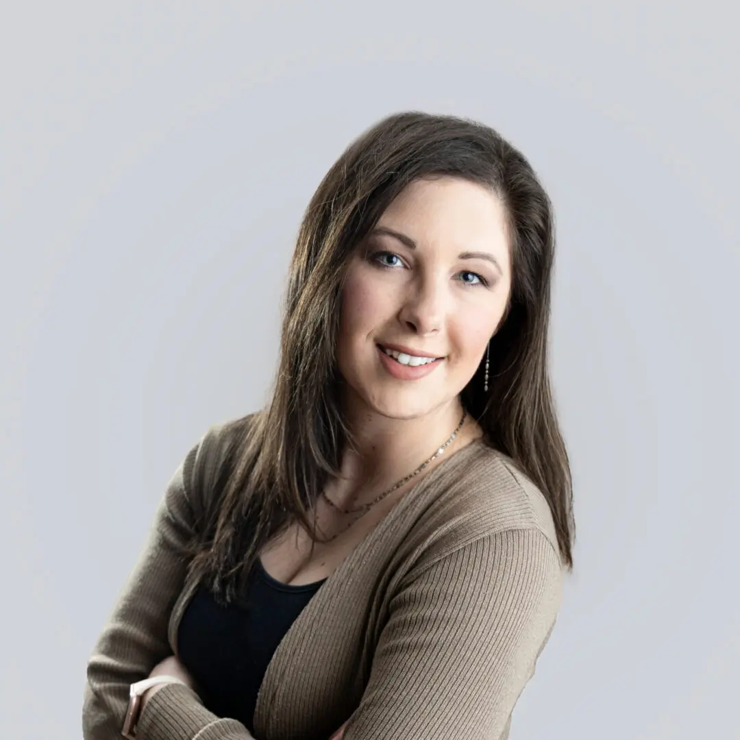 A woman standing with her arms crossed.