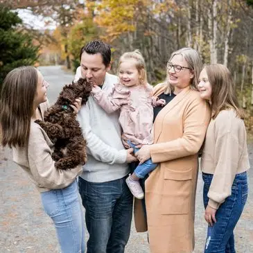 A family of five with one dog and two cats.