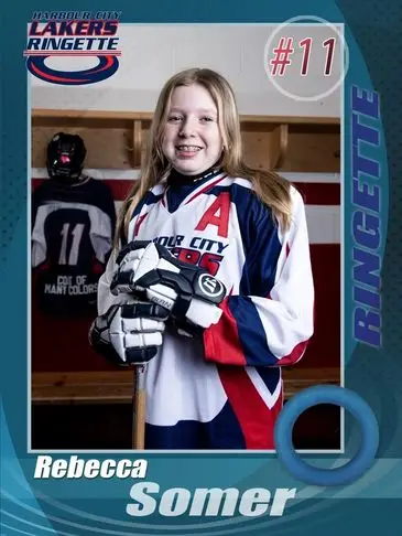 A girl in hockey gear posing for the camera.